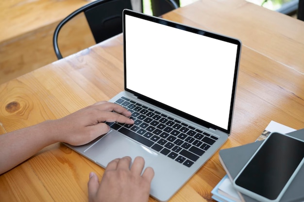 Businesswoman working with computer laptop at wooden office desk.