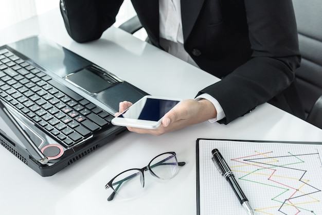 businesswoman working with modern devices, labtop computer and mobile phone on office desk