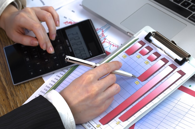 Businesswoman works with items for doing business in the office.