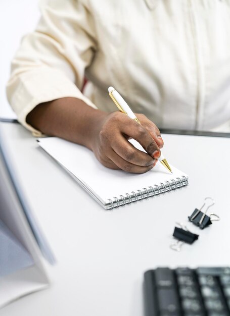 Businesswoman writing on a notepad