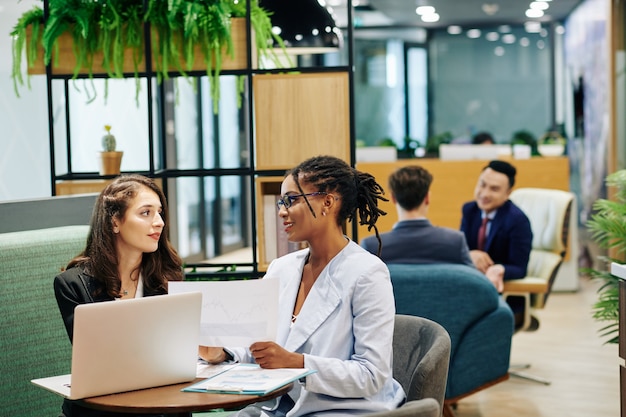 Businesswomen discussing details