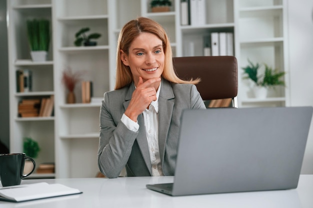 Busy by using laptop Woman in business formal clothes is working in office