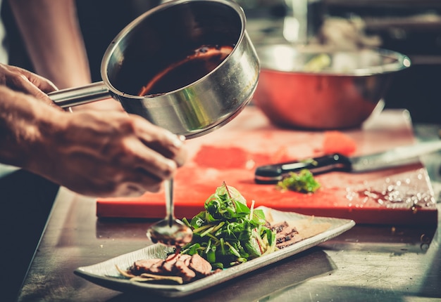 Busy chef at work in the restaurant kitchen