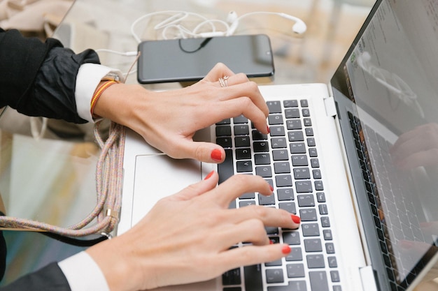 Busy woman working with laptop at workplace