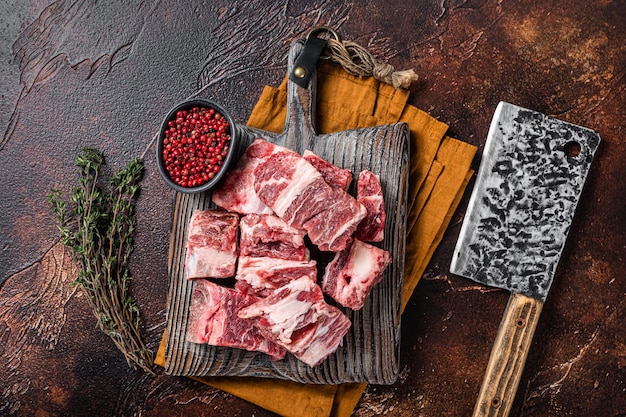 Butcher board with Raw diced beef and lamb meat ready for cooking Dark background Top view