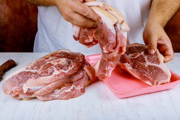 Butcher cooking pork meat on kitchen