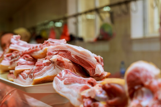 Butcher cuts a piece of meat in the market