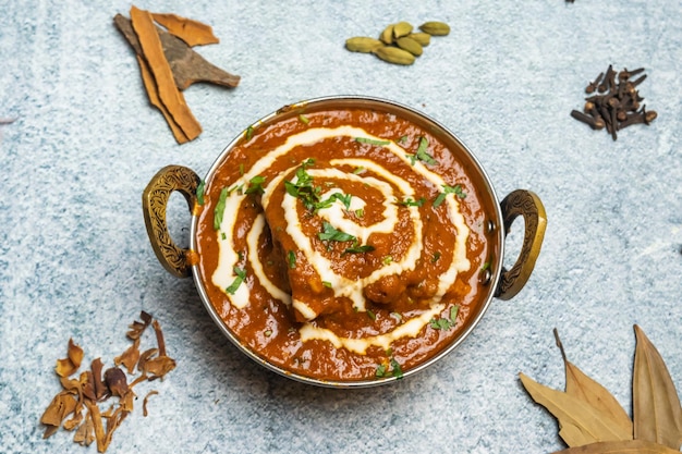 Butter Chicken karahi or chicken makhni with onion and chili served in a dish isolated on grey background top view of bangladesh food