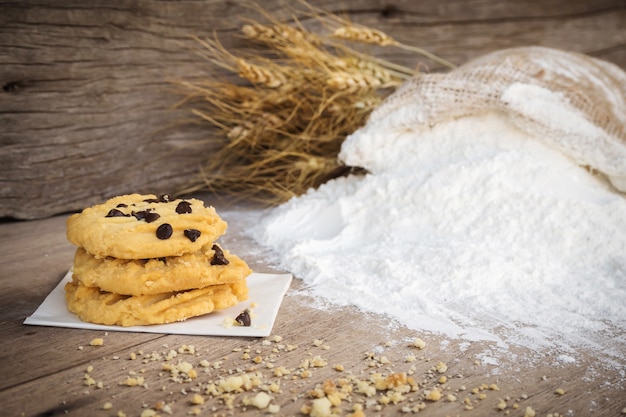 Butter cookies with chocolate chip topping on wooden background