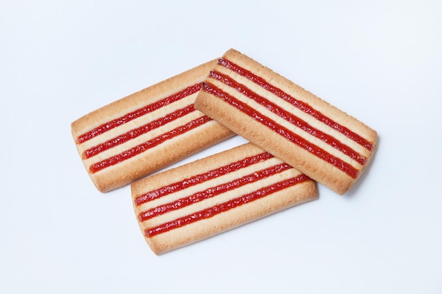 Butter cookies with jam on white background