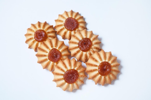 Butter cookies with jam on white background