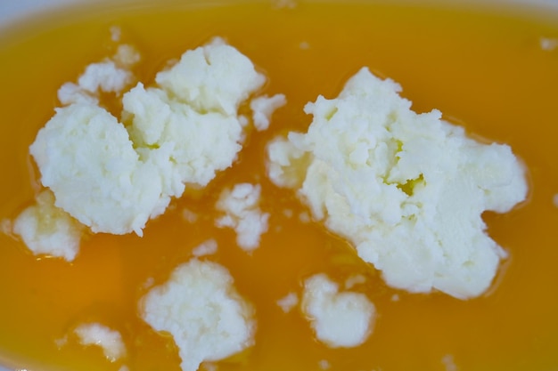 Butter cream and honey in a bowl on table