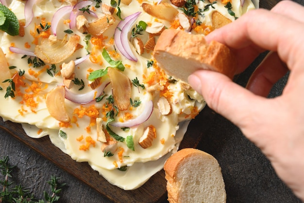 Butterboard with onion garlic orange herbs and crispy baguette