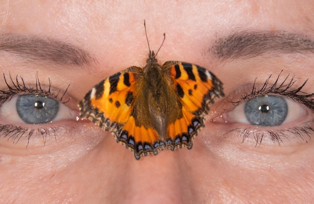 a butterfly sits on a woman's body