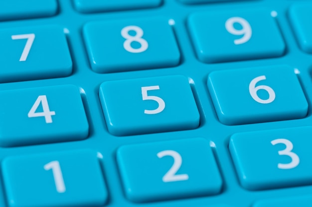 Button with numbers on a blue plastic calculator keyboard