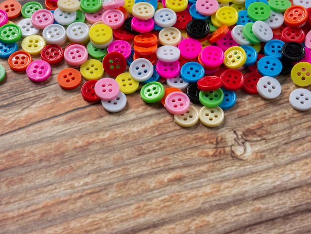 The Buttons multi color on wood table for diy or handcrafted  concept.