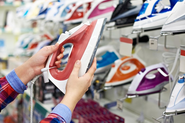 Buyer shopping for iron in store closeup