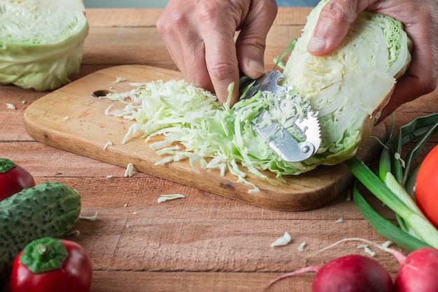 Cabbage and cutted cabbage on wooden table