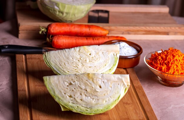 Cabbage on a cutting board carrot and knife next to it Prepare for fermentation