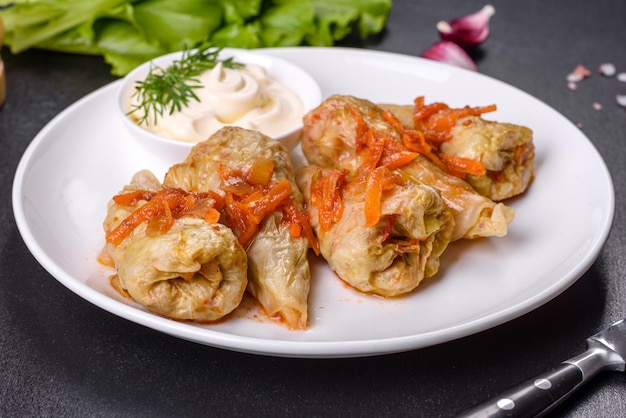 Cabbage rolls stuffed with ground beef and rice served on a white plate