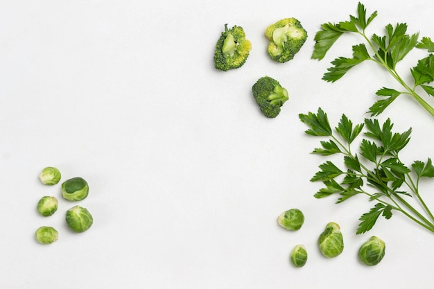 Cabbage and sprigs of parsley on white. Copy space. Flat lay. Food background.