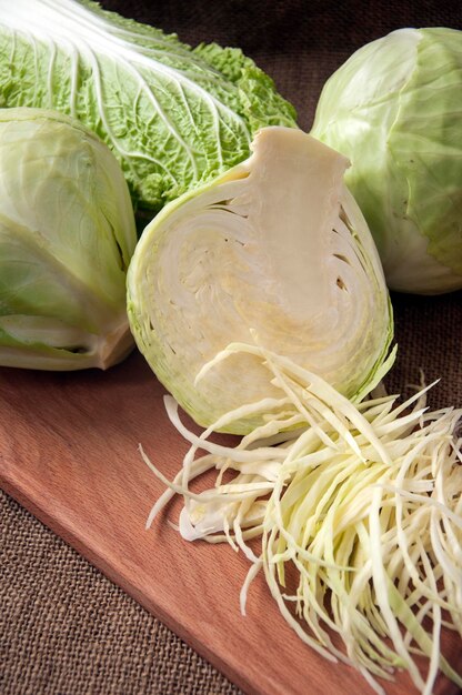 Cabbage on a wooden board on a background sacking, burlap