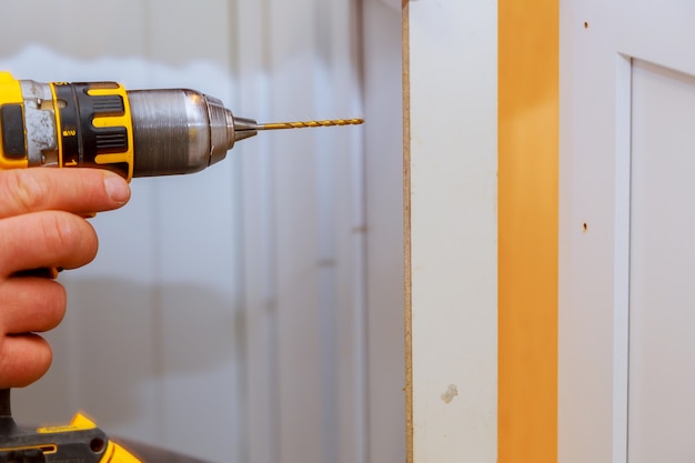 Cabinet door master drills the door in the cabinet door