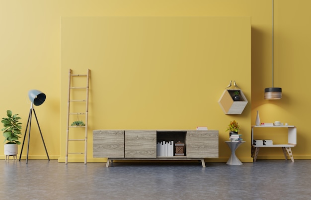 Cabinet TV in modern living room with lamp, table, flower and plant on yellow wall .