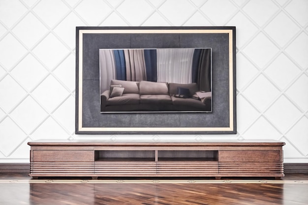 Cabinet for TV set made of veneer and solid oak lumber toned in dark brown color near molded wall