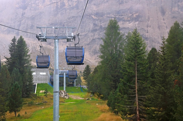 The cableway cabin does not work for climbing to the top of the mountain with a resting place restaurant and hotel on a foggy day Quarantine Dolomites Italy Selective focus