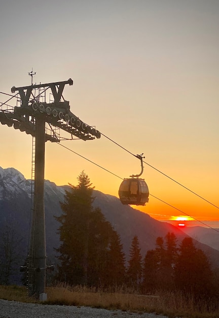 Cableway gondola in the mountains at sunset