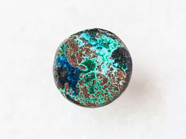 Cabochon from Chrysocolla gemstone on white