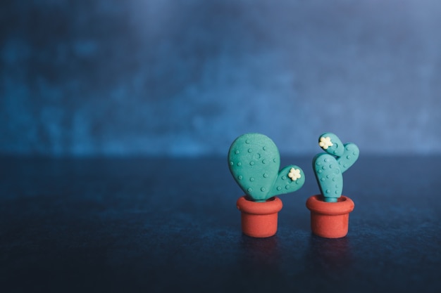 Cactus shaped erasers on a dark background Teaching concept Copyspace