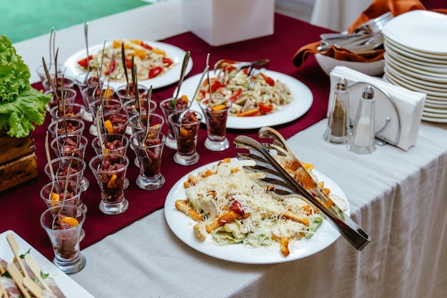 Caesar chicken salad with grated parmesan on a real event Closeup