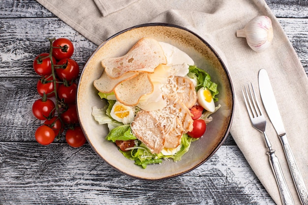 Caesar salad caesar with chicken salad on a white background side view