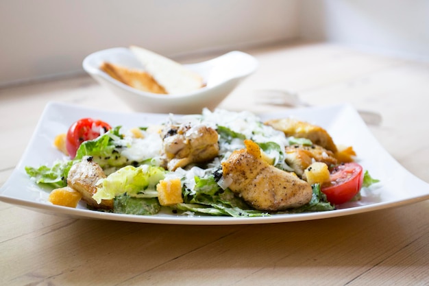 A Caesar salad is a salad of romaine lettuce croutons and chicken with lemon juice olive oil egg