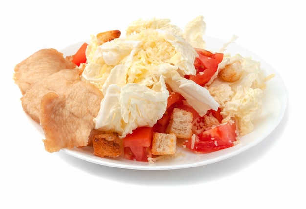 Caesar Salad with Chicken Fillet, Peking Cabbage, Parmesan Cheese, Crackers and Tomatoes. On a white plate. Isolated. On white background