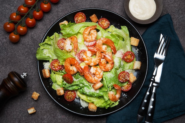 Caesar salad with shrimp, croutons and parmesan, top view