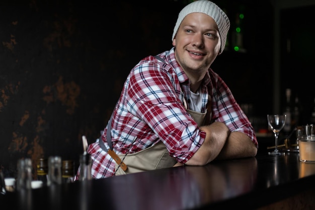 Cafe owner Pleasant delighted man sitting near the counter smiling