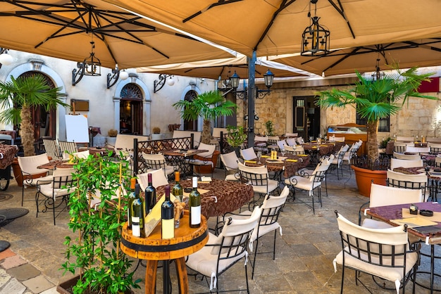 Cafe tables on cozy street of old town. Kotor, Montenegro