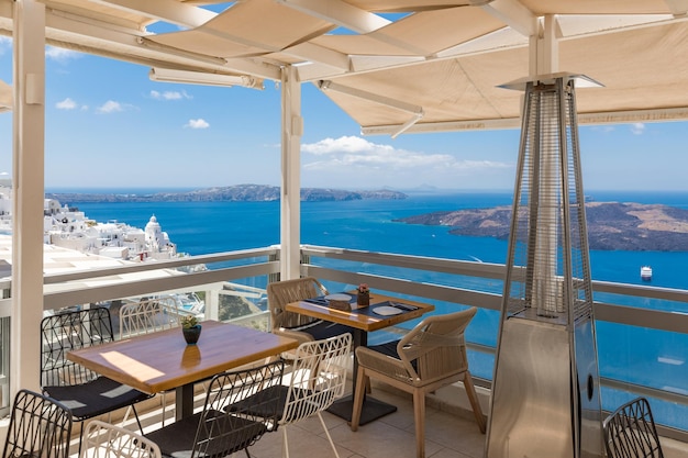 Cafe on the terrace overlooking the sea. Santorini island, Greece. Beautiful travel destination