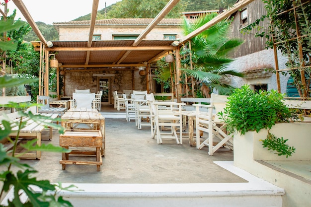 Cafe terrace with white furniture on the street without people