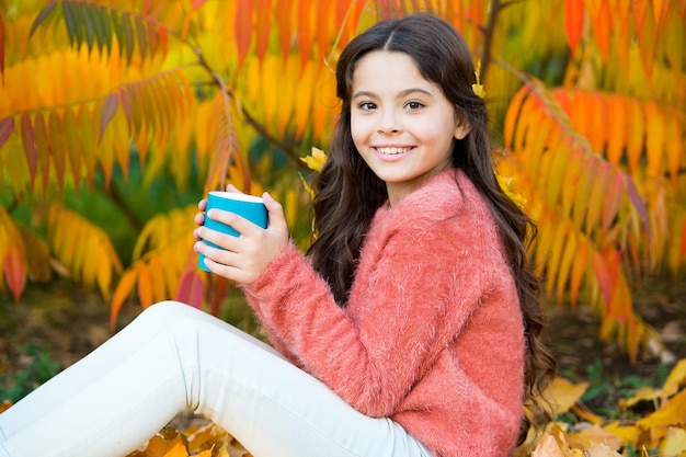 Caffeine addicted Little child hold cup with caffeine energy drink Small girl recharge with hot caffeine drink on crispy autumn Morning awakening better with coffee caffeine