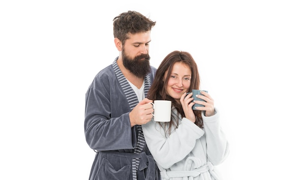 Caffeine power concept With coffee morning tastes better Couple relax in morning with coffee Couple enjoy lazy weekend and drink coffee Wife and husband bathrobes hold tea mug coffee cup