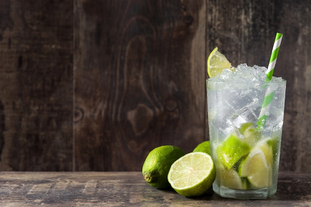 Caipirinha cocktail in glass on wooden table 