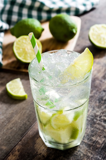 Caipirinha cocktail in glass on wooden table