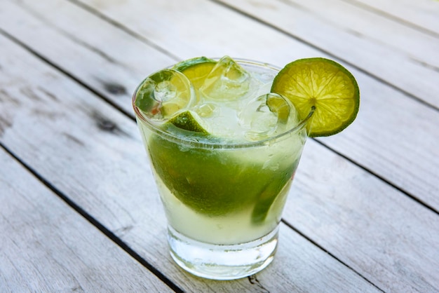 Caipirinha drink with lemon on an aged wooden table Typical Brazilian drink made with cachaca