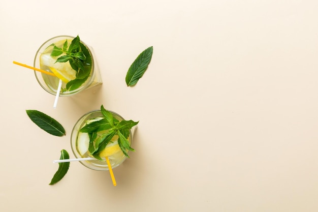 Caipirinha Mojito cocktail vodka or soda drink with lime mint and straw on table background Refreshing beverage with mint and lime in glass top view flat lay