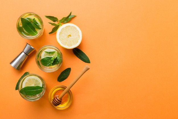 Caipirinha Mojito cocktail vodka or soda drink with lime mint and straw on table background Refreshing beverage with mint and lime in glass top view flat lay