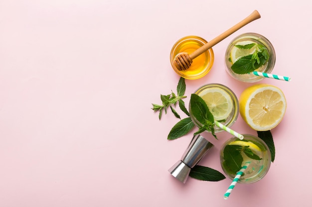 Caipirinha Mojito cocktail vodka or soda drink with lime mint and straw on table background Refreshing beverage with mint and lime in glass top view flat lay